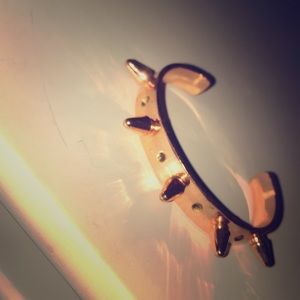 A gold metal shinny bracelet. Very cute, stylish.